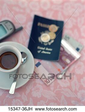 Stock Photo - cup of espresso, 
cell phone, passport 
and italian lire 
on cafe table. 
fotosearch - search 
stock photos, 
pictures, images, 
and photo clipart