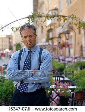 Stock Photo - prime businessman 
with folded arms, 
 standing by outdoor 
cafe,  rome. fotosearch 
- search stock 
photos, pictures, 
images, and photo 
clipart