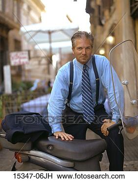 Stock Photo - prime businessman 
standing by motor 
scooter, rome, 
italy. fotosearch 
- search stock 
photos, pictures, 
images, and photo 
clipart