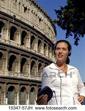 Stock Photo - prime woman wearing 
headphones,  listening 
to cd player, 
 standing in. 
fotosearch - search 
stock photos, 
pictures, images, 
and photo clipart