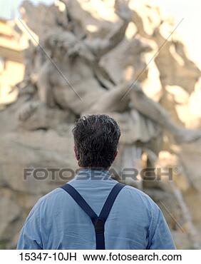 Stock Photo - rear view of prime 
businessman looking 
at fountain statue, 
 piazza. fotosearch 
- search stock 
photos, pictures, 
images, and photo 
clipart