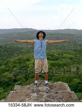 Stock Photo - man standing with 
arms extended 
on top of mayan 
ruin at xunantunich. 
fotosearch - search 
stock photos, 
pictures, images, 
and photo clipart