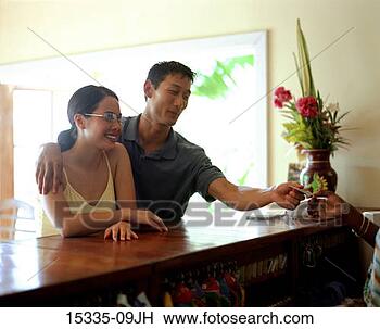 Stock Photo - couple checking 
in at hotel, man 
handing credit 
card to desk clerk. 
fotosearch - search 
stock photos, 
pictures, images, 
and photo clipart
