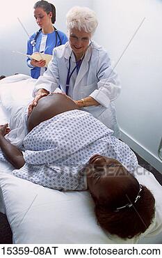 Stock Photo - mature female 
doctor examining 
pregnant middle-aged 
woman while nurse. 
fotosearch - search 
stock photos, 
pictures, images, 
and photo clipart