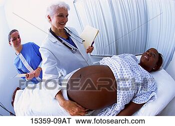 Stock Photo - mature female 
doctor examining 
pregnant middle-aged 
woman while nurse. 
fotosearch - search 
stock photos, 
pictures, images, 
and photo clipart