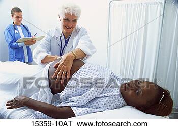 Stock Photo - mature female 
doctor examining 
pregnant middle-aged 
woman while nurse. 
fotosearch - search 
stock photos, 
pictures, images, 
and photo clipart