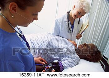 Stock Photo - mature female 
doctor examining 
pregnant middle-aged 
woman while nurse. 
fotosearch - search 
stock photos, 
pictures, images, 
and photo clipart