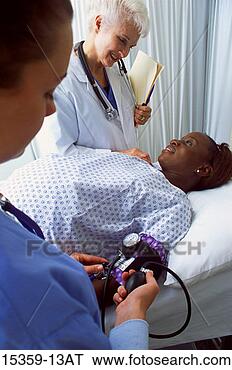 Stock Photo - mature female 
doctor examining 
pregnant middle-aged 
woman while nurse. 
fotosearch - search 
stock photos, 
pictures, images, 
and photo clipart
