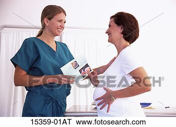 Stock Photo - middle-aged pregnant 
hispanic woman 
having discussion 
with young. fotosearch 
- search stock 
photos, pictures, 
images, and photo 
clipart