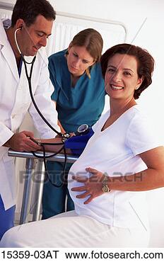 Stock Photo - middle-aged pregnant 
hispanic woman 
having blood pressure 
measured by. fotosearch 
- search stock 
photos, pictures, 
images, and photo 
clipart