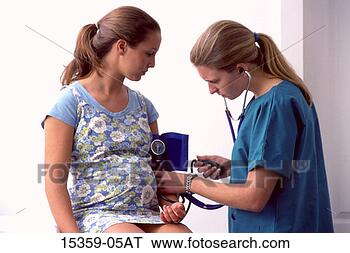 Stock Photo - pregnant teenage 
girl having blood 
pressure checked 
by young female. 
fotosearch - search 
stock photos, 
pictures, images, 
and photo clipart