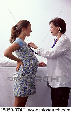 Stock Photo - pregnant teenage 
girl being examined 
by middle-aged 
hispanic female. 
fotosearch - search 
stock photos, 
pictures, images, 
and photo clipart