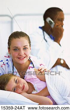 Stock Photo - young girl lying 
in hospital bed 
as pediatric female 
nurse leans. fotosearch 
- search stock 
photos, pictures, 
images, and photo 
clipart