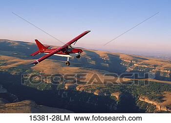 Stock Photo - gladstar sportsman 
airplane in flight 
above canyon, 
montana. fotosearch 
- search stock 
photos, pictures, 
images, and photo 
clipart