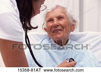 Stock Photo - elderly woman 
being examined 
by female doctor 
with stethoscope. 
fotosearch - search 
stock photos, 
pictures, images, 
and photo clipart