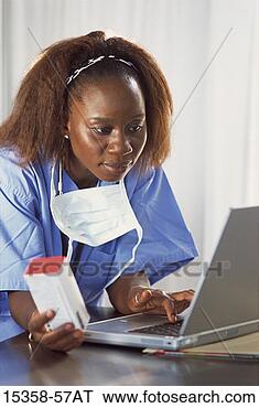 Stock Photo - middle-aged female 
(35) doctor/nurse 
in surgical scrubs, 
 holding. fotosearch 
- search stock 
photos, pictures, 
images, and photo 
clipart