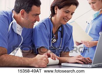 Stock Photo - middle-aged hispanic 
male (40s) doctor/nurse 
wearing surgical 
scrubs. fotosearch 
- search stock 
photos, pictures, 
images, and photo 
clipart
