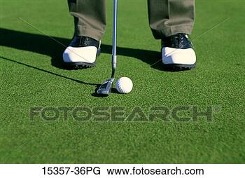 Stock Photo - male golfer's 
feet,  putter 
and golf ball 
as he prepares 
to putt on. fotosearch 
- search stock 
photos, pictures, 
images, and photo 
clipart
