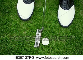 Stock Photo - male golfer's 
feet,  putter 
and golf ball 
as he prepares 
to putt on. fotosearch 
- search stock 
photos, pictures, 
images, and photo 
clipart