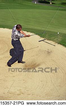 Stock Photo - middle-aged male 
golfer chipping 
out of sand trap 
on property. fotosearch 
- search stock 
photos, pictures, 
images, and photo 
clipart