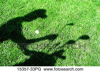 Stock Photo - shadow of male 
golfer taking 
club from golf 
bag and golf ball 
lying. fotosearch 
- search stock 
photos, pictures, 
images, and photo 
clipart