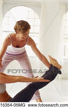 Stock Photo - yoga instructor 
and student in 
yoga class,  full 
boat posture. 
fotosearch - search 
stock photos, 
pictures, images, 
and photo clipart