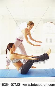 Stock Photo - yoga instructor 
and student in 
yoga class,  full 
boat posture. 
fotosearch - search 
stock photos, 
pictures, images, 
and photo clipart
