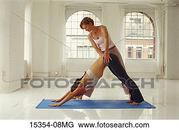 Stock Photo - yoga instructor 
and student in 
yoga class,  downward 
facing dog. fotosearch 
- search stock 
photos, pictures, 
images, and photo 
clipart