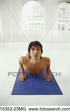 Stock Photo - young man doing 
bikram (hot) yoga, 
cobra posture. 
fotosearch - search 
stock photos, 
pictures, images, 
and photo clipart