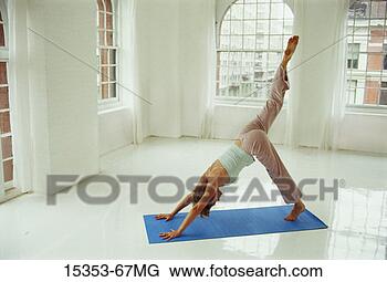 Stock Photo - young woman in 
yoga posture, 
half-downward 
facing dog posture. 
fotosearch - search 
stock photos, 
pictures, images, 
and photo clipart