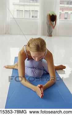 Stock Photo - young woman in 
yoga posture, 
 cow's face seated 
posture with hand 
in. fotosearch 
- search stock 
photos, pictures, 
images, and photo 
clipart