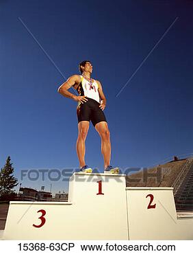 Stock Photo - male track contestant 
wearing medal 
around his neck 
standing on first. 
fotosearch - search 
stock photos, 
pictures, images, 
and photo clipart