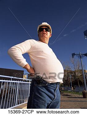 Stock Photo - profile of construction 
worker with pot 
belly standing 
outdoors. fotosearch 
- search stock 
photos, pictures, 
images, and photo 
clipart