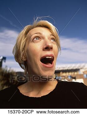 Stock Photo - woman with surprised 
look, looking 
up at sky, headshot 
outdoors. fotosearch 
- search stock 
photos, pictures, 
images, and photo 
clipart