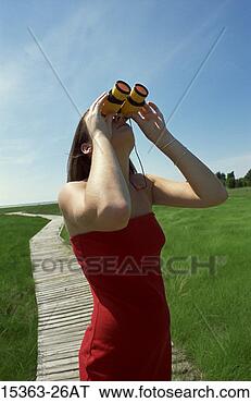 Stock Photo - teenage girl looking 
at sky through 
toy binoculars 
as she stands 
on. fotosearch 
- search stock 
photos, pictures, 
images, and photo 
clipart