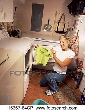 Stock Photo - distressed woman 
holding up shrunken 
sweater that accidentally 
went. fotosearch 
- search stock 
photos, pictures, 
images, and photo 
clipart