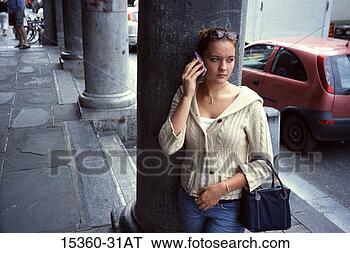 Stock Photo - teenage girl on 
cell phone,  as 
she stands by 
column on city. 
fotosearch - search 
stock photos, 
pictures, images, 
and photo clipart
