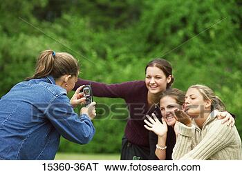 Stock Photo - teenage girl taking 
photograph with 
cell phone camera 
of three. fotosearch 
- search stock 
photos, pictures, 
images, and photo 
clipart