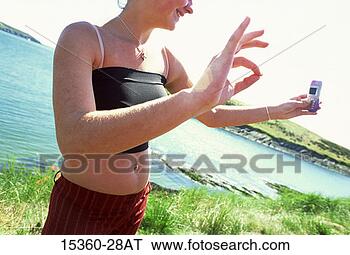Stock Photo - teenage girl talking 
cell phone photo 
of her hand making 
