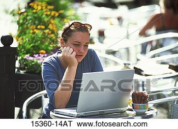 Stock Photo - teenage girl using 
laptop computer 
as she sits in 
outdoor cafe having. 
fotosearch - search 
stock photos, 
pictures, images, 
and photo clipart
