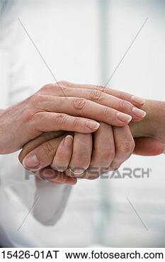 Stock Photo - medical caregiver's 
hand holding patient's 
hand. fotosearch 
- search stock 
photos, pictures, 
images, and photo 
clipart