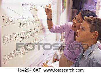 Stock Photo - teacher and teenage 
boy looking at 
white board in 
science class. 
fotosearch - search 
stock photos, 
pictures, images, 
and photo clipart