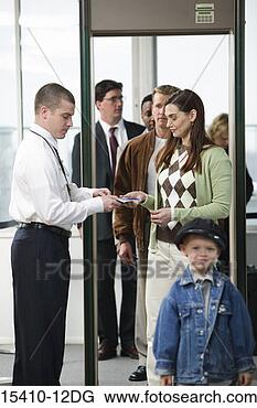 Stock Photo - airport security 
guard checking 
travelers at security 
gate. fotosearch 
- search stock 
photos, pictures, 
images, and photo 
clipart