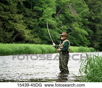 Stock Photo - mature man fly 
fishing. fotosearch 
- search stock 
photos, pictures, 
images, and photo 
clipart