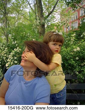 Stock Photo - mother and daughter 
in park,  daughter 
holding her hands 
over mom's. fotosearch 
- search stock 
photos, pictures, 
images, and photo 
clipart