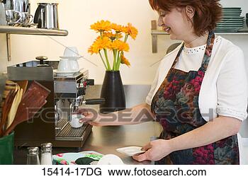 Stock Photo - woman making espresso 
in kitchen. fotosearch 
- search stock 
photos, pictures, 
images, and photo 
clipart