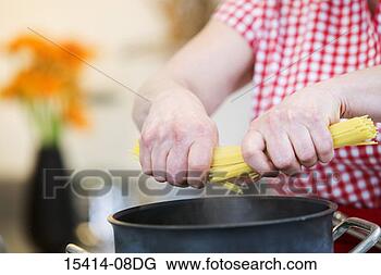 Stock Photo - woman's hands 
cooking pasta 
in kitchen. fotosearch 
- search stock 
photos, pictures, 
images, and photo 
clipart