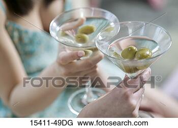 Stock Photo - two women toasting 
martini glasses, 
close-up of glasses. 
fotosearch - search 
stock photos, 
pictures, images, 
and photo clipart