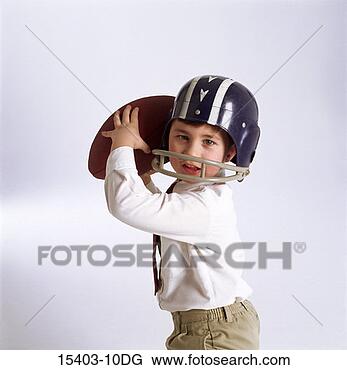Stock Photo - boy wearing football 
helmet and holding 
football. fotosearch 
- search stock 
photos, pictures, 
images, and photo 
clipart