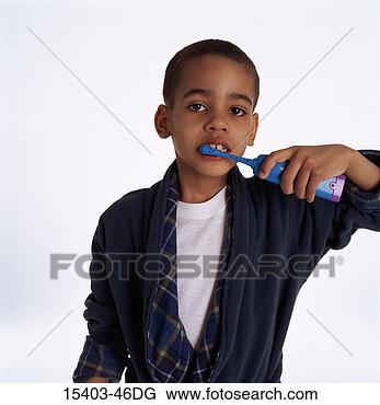 Stock Photo - young boy in robe, 
brushing his teeth 
with battery operated 
toothbrush. fotosearch 
- search stock 
photos, pictures, 
images, and photo 
clipart